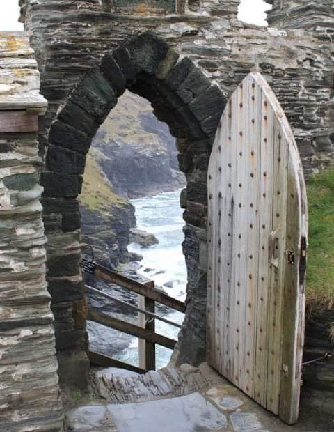 Stone archway with view of water beyond it